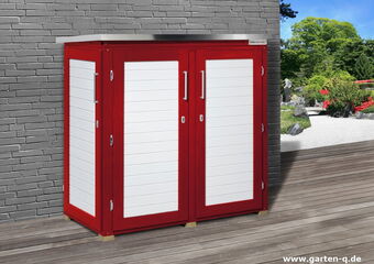 The image shows a garden storage cabinet with a red and white design. It is placed against a brick wall on a wooden deck, with a garden visible in the background. The cabinet has a metal top and two doors with handles.
