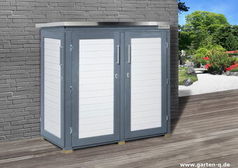 The image shows a modern outdoor storage cabinet placed against a brick wall. It has a sleek design with horizontal slats in a contrasting color, and two vertical handles on the front doors. The setting includes a wooden deck leading to a landscaped garden with greenery and flowers.