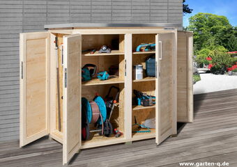 The image shows an open outdoor storage cabinet made of wood. Inside, there are various garden tools and equipment organized on shelves. Items include:

1. A long-handled tool.
2. A hose reel.
3. An electric hedge trimmer.
4. A cordless drill or similar power tool.
5. Gardening shears.
6. Other small garden tools and accessories.

The cabinet is located on a deck or patio with a garden in the background.