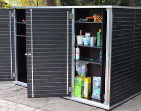. The image shows a garden storage cabinet with its doors open. Inside, there are various items such as plant pots, gardening tools, spray bottles, boxes, and containers, likely used for garden maintenance. There's also an open space in the cabinet, which can be used for storing larger items.