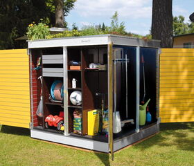 . The image depicts a compact garden shed with open doors, revealing its contents. Inside, there are various gardening and outdoor items organized on shelves and hooks. You can see items like a garden hose, a watering can, a soccer ball, a child's toy car, gardening tools, and bags of gardening supplies. The shed has a modern design with yellow doors and a green roof with plants.