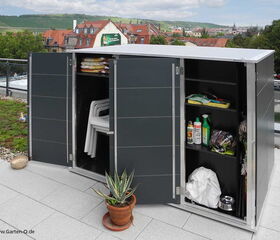 . The image shows an outdoor storage cabinet with its doors open. Inside, the cabinet contains:

1. On the left side:
   - A stack of folded patio cushions or similar items.
   - A set of stacked white plastic outdoor chairs.

2. On the right side:
   - Various gardening supplies including a spray bottle, some containers, and garden soil or fertilizer bags.
   - A metal bowl at the bottom.
   - Some plastic bags or possibly a fabric cover at the bottom. 

The cabinet is situated on a rooftop or terrace with a view of a town and green hills. There are also potted plants in front of the cabinet.