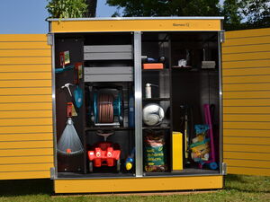 . The image shows an organized storage unit or garden shed with the following items:

1. Garden tools (such as a rake and small hand tools)
2. A hose reel
3. A red toy car
4. A soccer ball
5. A bag of charcoal briquettes
6. Cleaning supplies
7. Some gardening or household accessories
8. A watering can

The structure is yellow with two open doors, and there are plants on top.