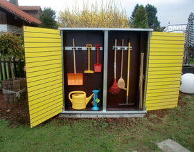. The image shows a garden storage cabinet with yellow doors, which is open to reveal several gardening tools and items inside:

1. A yellow watering can.
2. A small red shovel.
3. A yellow hand rake.
4. A large red rake.
5. A broom.
6. A long-handled rake.
7. Some bamboo stakes or similar long items.
8. Smaller tools and a toy-like item in blue.

The cabinet appears to be outdoors on a lawn.