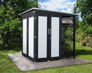 The image shows a modern outdoor storage shed with a sleek design, featuring white paneled doors and a dark frame. It's situated on a tiled platform in a garden area. There's a bicycle and another item stored in the open side section of the shed. Surrounding the shed is a grassy lawn with trees and hedges.