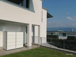 . Modernes weißes Gebäude mit Geländer, schlichten Linien und Gartenbereich im Freien.