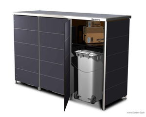 . The image shows a storage unit with a partially open door. Inside, there are two wheeled bins and some cardboard boxes stacked on top of them. The boxes appear to have branding on them. The storage unit is labeled "Garten Q" and is designed for outdoor use.
