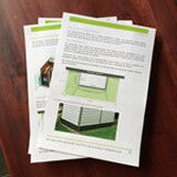 The image shows a stack of printed pages with text and images on them. The top page features some paragraphs of text and a photograph of what appears to be a building or structure.