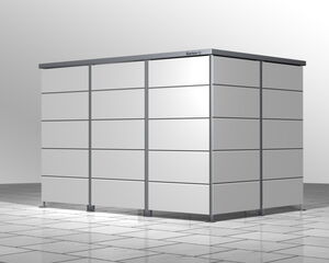 The image shows a modern storage shed with a sleek, modular design. It's composed of panels and has a simple, metallic appearance. The floor is tiled, and the structure appears to be designed for outdoor use.