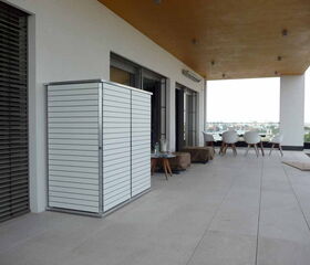 . The image depicts a modern, outdoor patio area. Items visible include:

1. White vertical slatted cabinet or storage unit on the left.
2. Large windows with horizontal blinds.
3. Beige-tiled floor.
4. Small tables with a glass bottle and pitchers.
5. Chairs in a contemporary white design.
6. Covered items, possibly furniture, in the center.
7. Ceiling with recessed lighting.
8. Overhanging wooden ceiling.
9. A distant view of a cityscape beyond the patio.

This setup suggests a comfortable, stylish outdoor space likely used for relaxation or entertaining.